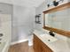 Bathroom featuring a vanity with wood cabinets, a mirror and a shower/tub combo at 13839 Fairway Island Dr # 1128, Orlando, FL 32837