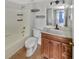 Well-lit bathroom featuring a shower/tub combo, toilet, and vanity with wood cabinets at 13839 Fairway Island Dr # 1128, Orlando, FL 32837
