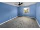 Cozy carpeted bedroom with a ceiling fan and large window offering a bright and airy feel at 13839 Fairway Island Dr # 1128, Orlando, FL 32837