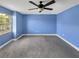 Bedroom featuring a ceiling fan, neutral carpet, and natural light from the window at 13839 Fairway Island Dr # 1128, Orlando, FL 32837