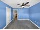 Bedroom with ensuite bathroom, carpet, ceiling fan, and natural light from the window at 13839 Fairway Island Dr # 1128, Orlando, FL 32837