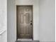 Neutral-colored condo front door with an elegant knocker and secure electronic lock at 13839 Fairway Island Dr # 1128, Orlando, FL 32837