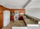 Kitchen with granite countertops, white appliances, tile backsplash, and wood cabinets at 13839 Fairway Island Dr # 1128, Orlando, FL 32837