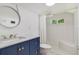 Beautiful bathroom features a modern vanity and tiled shower-tub combo at 1405 Pioneer Trl, New Smyrna Beach, FL 32168