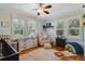 Bright Bedroom featuring hardwood floors and large windows overlooking backyard at 1405 Pioneer Trl, New Smyrna Beach, FL 32168