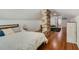 Bedroom featuring exposed brick, wood floors, and neutral color palette at 1405 Pioneer Trl, New Smyrna Beach, FL 32168