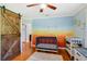 Beautiful Bedroom features hardwood floors, a colorful wall mural, and ample storage at 1405 Pioneer Trl, New Smyrna Beach, FL 32168
