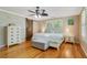 Stylish bedroom featuring a sliding barn door, hardwood floors, and plenty of closet space at 1405 Pioneer Trl, New Smyrna Beach, FL 32168