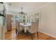 Bright dining area with natural light, hardwood floors, and elegant light fixture at 1405 Pioneer Trl, New Smyrna Beach, FL 32168