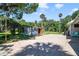 Outbuilding with an entertainment area, palm trees, and paver parking make this property inviting at 1405 Pioneer Trl, New Smyrna Beach, FL 32168