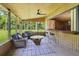Relaxing screened lanai with a ceiling fan, bar and seating area for entertaining or simply relaxing at 1405 Pioneer Trl, New Smyrna Beach, FL 32168