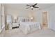Bright bedroom with carpet, fan, and a queen bed dressed in white linens at 14374 Lanikai Beach Dr, Orlando, FL 32827