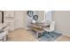 Dining area features an elongated wood table with seating for six, all set atop a decorative blue rug at 14374 Lanikai Beach Dr, Orlando, FL 32827
