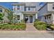 Charming two-story home featuring a lovely front porch and professionally landscaped yard with attractive shrubbery at 14374 Lanikai Beach Dr, Orlando, FL 32827