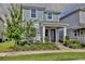 Charming two-story home with a lovely brick path to the entry and professionally landscaped front yard at 14374 Lanikai Beach Dr, Orlando, FL 32827