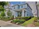 Beautiful two-story home with lush landscaping and a brick pathway leading to a cozy front porch at 14374 Lanikai Beach Dr, Orlando, FL 32827
