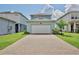 Two car garage with long brick driveway, offering ample parking at 14374 Lanikai Beach Dr, Orlando, FL 32827