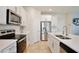 Kitchen featuring white cabinets, stainless steel appliances, tile flooring, and a kitchen island at 14374 Lanikai Beach Dr, Orlando, FL 32827