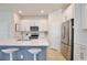 Bright kitchen features white cabinets, stainless steel appliances, and center island with barstool seating at 14374 Lanikai Beach Dr, Orlando, FL 32827