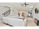 Spacious living room featuring tile flooring, a ceiling fan, a large sofa and an open concept layout at 14374 Lanikai Beach Dr, Orlando, FL 32827