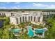 Aerial view of a luxury resort with multiple pools, lush landscaping, and lake views at 14501 Grove Resort Ave # 3335, Winter Garden, FL 34787