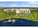 Aerial view of a resort featuring a private dock, water views and lots of pools at 14501 Grove Resort Ave # 3335, Winter Garden, FL 34787