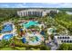 Stunning aerial view of resort pools, slides, palm trees, and the condo buildings at 14501 Grove Resort Ave # 3335, Winter Garden, FL 34787
