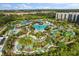 Aerial view of resort and water park featuring pools, lounge chairs, and splash pad at 14501 Grove Resort Ave # 3335, Winter Garden, FL 34787