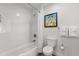 Bright bathroom with shower-tub combo, modern fixtures, and tasteful wall art at 14501 Grove Resort Ave # 3335, Winter Garden, FL 34787