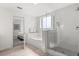 Bright bathroom featuring a shower with glass door and a separate bathtub at 14501 Grove Resort Ave # 3335, Winter Garden, FL 34787
