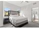 Bright bedroom featuring plush gray carpeting, large windows, and neutral-toned furnishings at 14501 Grove Resort Ave # 3335, Winter Garden, FL 34787