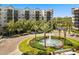 Attractive building facade featuring lush landscaping, a decorative fountain, and inviting curb appeal at 14501 Grove Resort Ave # 3335, Winter Garden, FL 34787