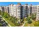 Upscale condo building with balconies, decorative turrets, and beautifully landscaped grounds at 14501 Grove Resort Ave # 3335, Winter Garden, FL 34787