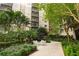 Seating area in a lush garden with white tables and chairs outside of a condo at 14501 Grove Resort Ave # 3335, Winter Garden, FL 34787