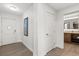 Hallway with clean lines leading to a bathroom and a bedroom entrance at 14501 Grove Resort Ave # 3335, Winter Garden, FL 34787