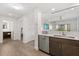 Kitchen with stainless steel dishwasher, brown cabinets, and an open view to the living room at 14501 Grove Resort Ave # 3335, Winter Garden, FL 34787