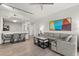 Open-concept living space featuring a modern sofa, dining area, and bright lighting at 14501 Grove Resort Ave # 3335, Winter Garden, FL 34787