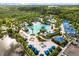 Aerial view of the resort's luxury pool area with ample seating, water features, and lush landscaping at 14501 Grove Resort Ave # 3335, Winter Garden, FL 34787
