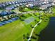 Aerial view of the community park basketball court surrounded by walking paths and lush landscaping at 1624 Tropical Palms Cir, Kissimmee, FL 34747