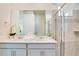 Modern bathroom with double vanity, quartz countertops, a glass enclosed shower and neutral color palette at 1624 Tropical Palms Cir, Kissimmee, FL 34747