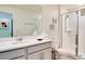 Bright bathroom featuring a white vanity with a clean sink and a glass-enclosed walk-in shower at 1624 Tropical Palms Cir, Kissimmee, FL 34747