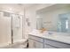 Well-lit bathroom featuring a modern vanity with a sink and a walk-in shower at 1624 Tropical Palms Cir, Kissimmee, FL 34747