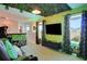Themed entertainment room featuring a large screen television and camouflage decor at 1624 Tropical Palms Cir, Kissimmee, FL 34747