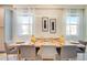 Bright dining room featuring a modern chandelier, decorative vases, and neutral-toned chairs at 1624 Tropical Palms Cir, Kissimmee, FL 34747