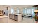 Open concept kitchen and living area featuring a large island, stainless appliances, and seamless transition to living space at 1624 Tropical Palms Cir, Kissimmee, FL 34747