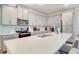 Bright kitchen with a large island, quartz countertops, stainless appliances, and modern white cabinetry at 1624 Tropical Palms Cir, Kissimmee, FL 34747