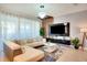 Chic living room with a large sectional sofa, stylish decor, and abundant natural light creating a comfortable atmosphere at 1624 Tropical Palms Cir, Kissimmee, FL 34747