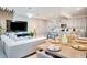 Open-concept living room with a large sectional sofa, dining area, and modern kitchen with bar seating at 1624 Tropical Palms Cir, Kissimmee, FL 34747