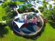 Aerial view of playground with colorful equipment, a sun shade, and grassy lawn at 1624 Tropical Palms Cir, Kissimmee, FL 34747