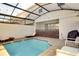 A private pool in a screened-in patio area with lounge chairs and outdoor seating at 1624 Tropical Palms Cir, Kissimmee, FL 34747